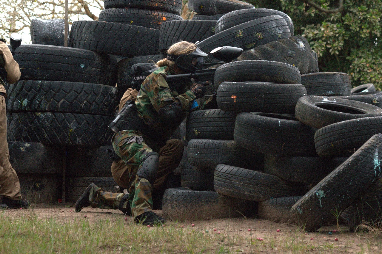 Paintball teammates moving together behind cover